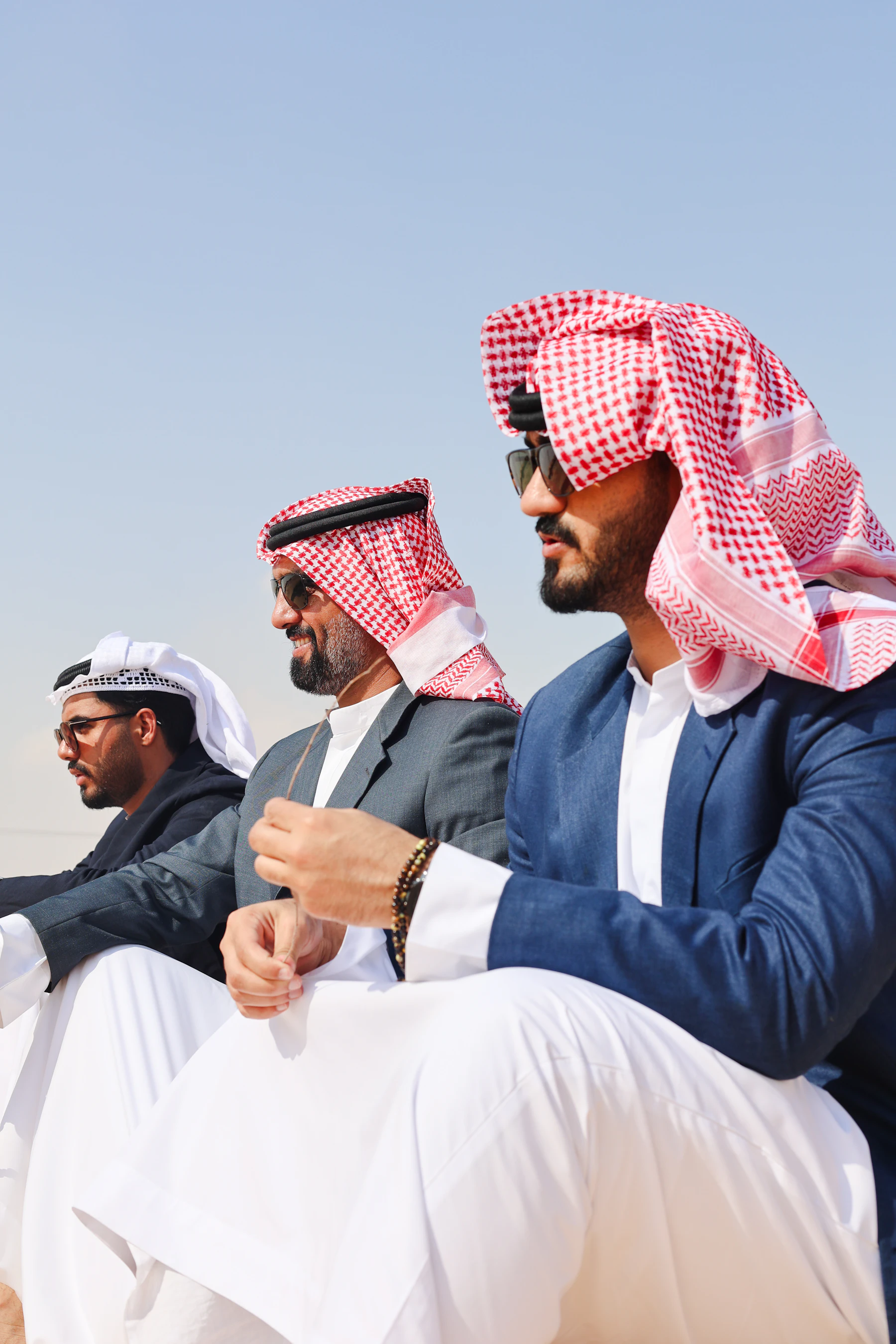Emirati men in traditional kandura sitting together