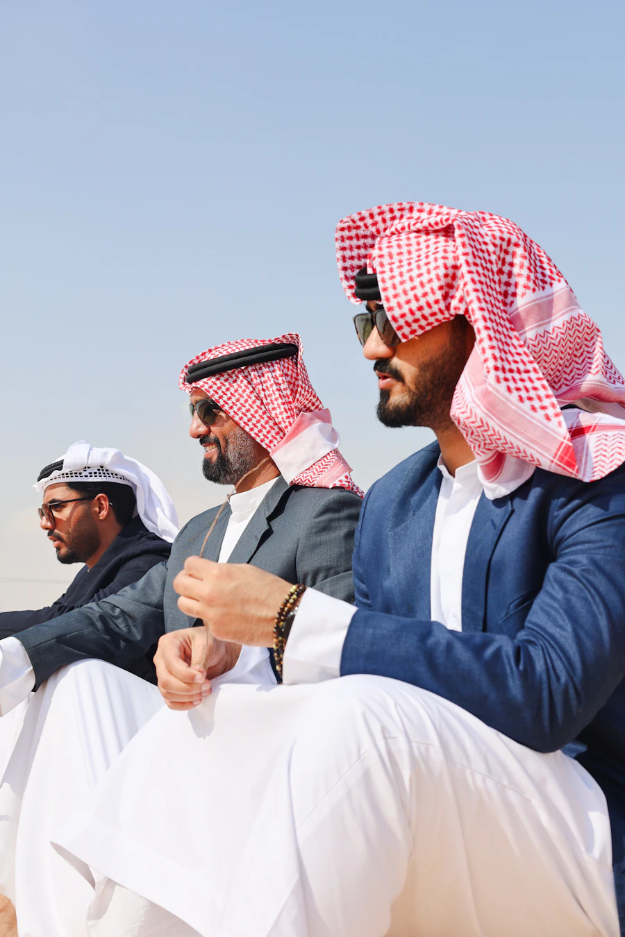 Emirati men in traditional kandura sitting together