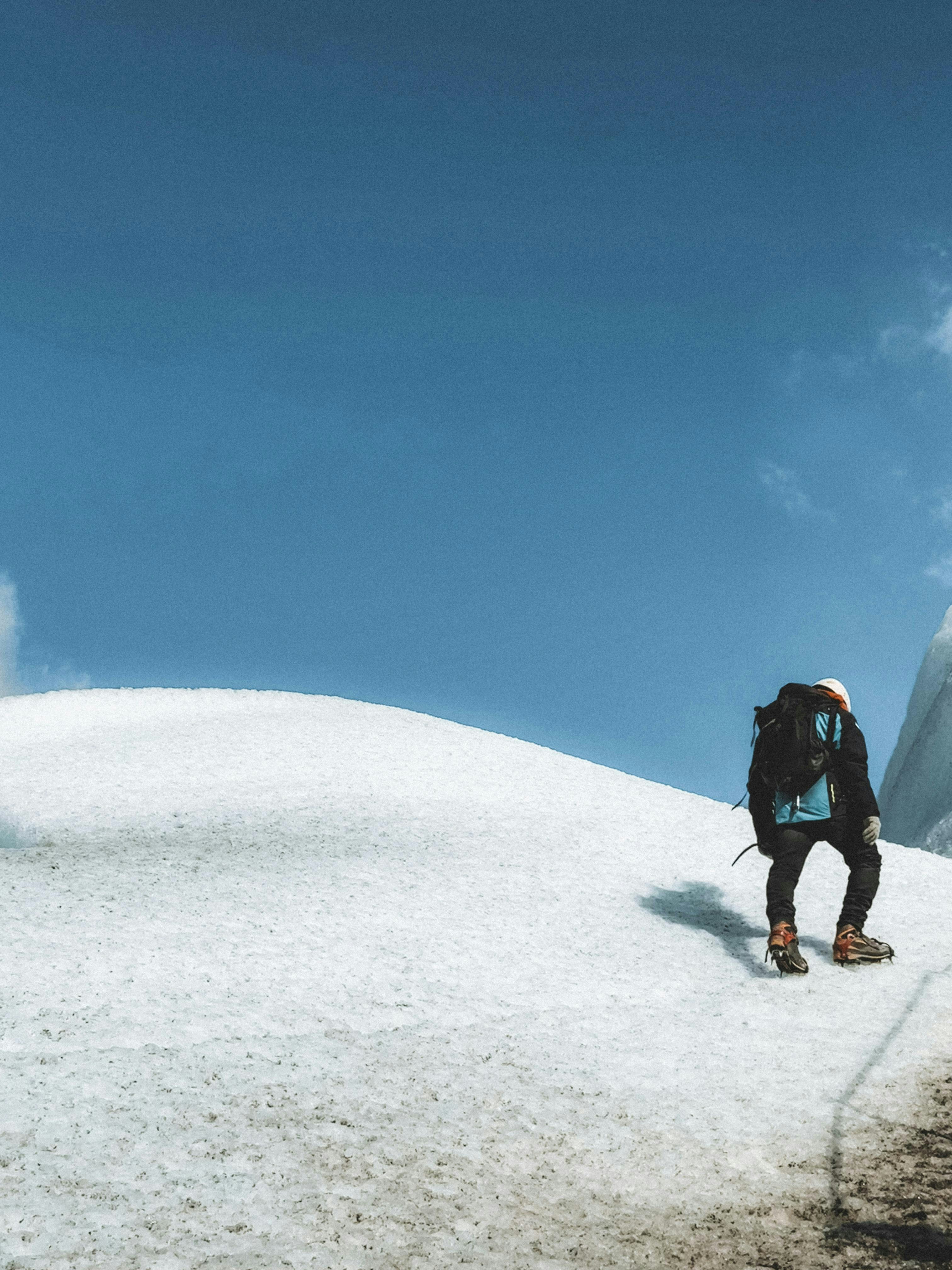 A man standing on top of a snow covered slope