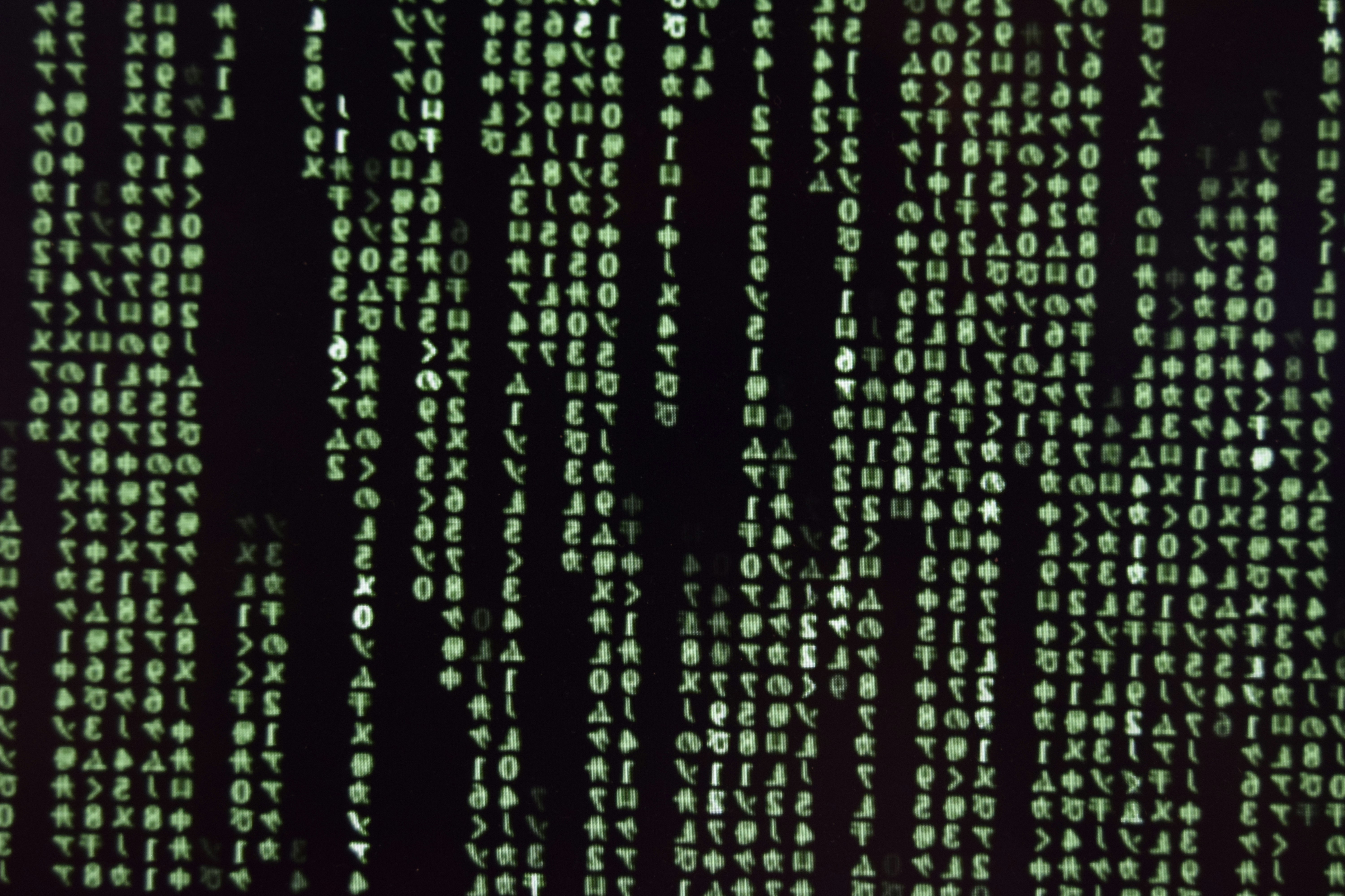 Matrix-style code rain effect with green characters falling on black background