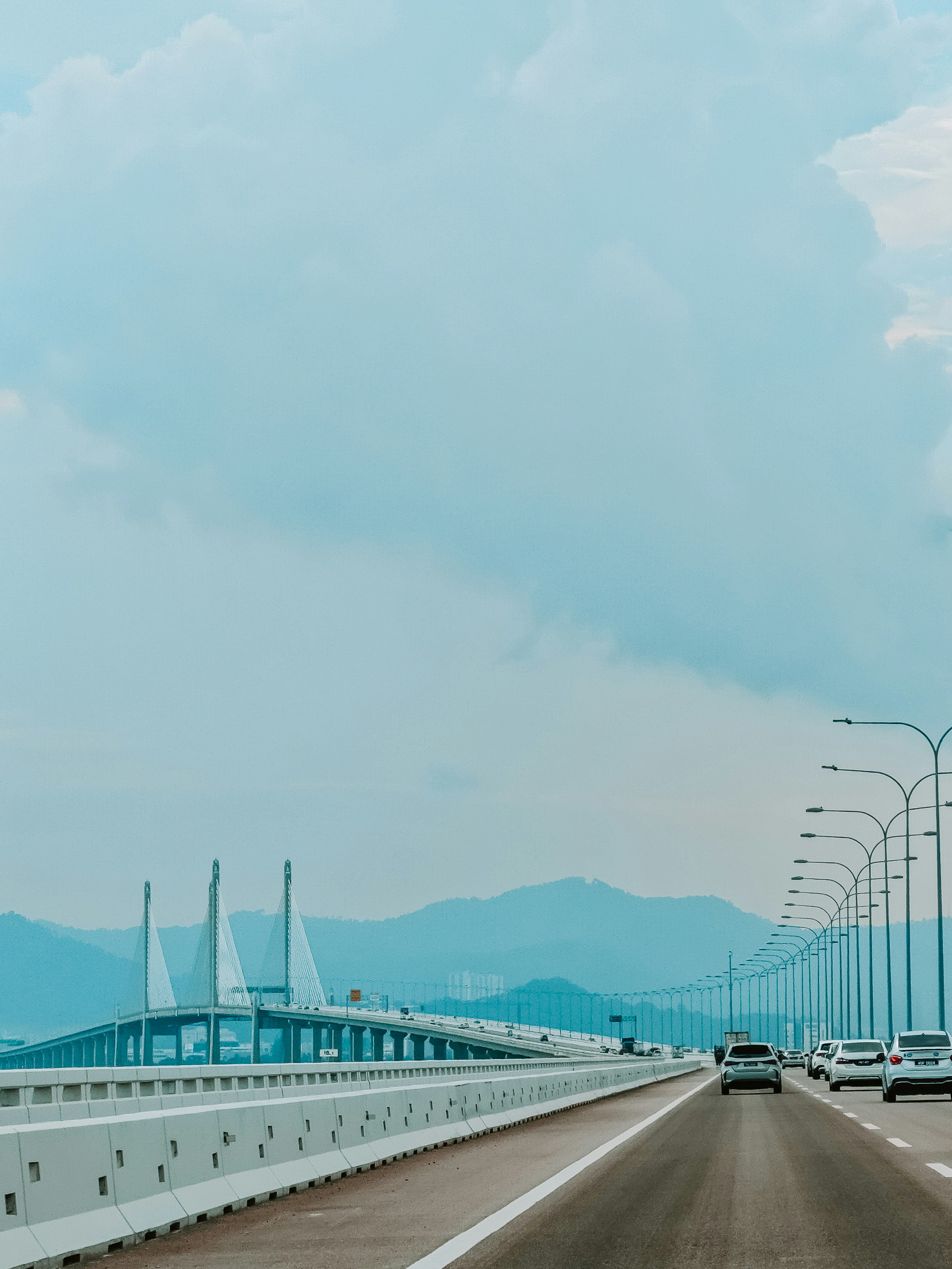 A view of a highway with a bridge in the background