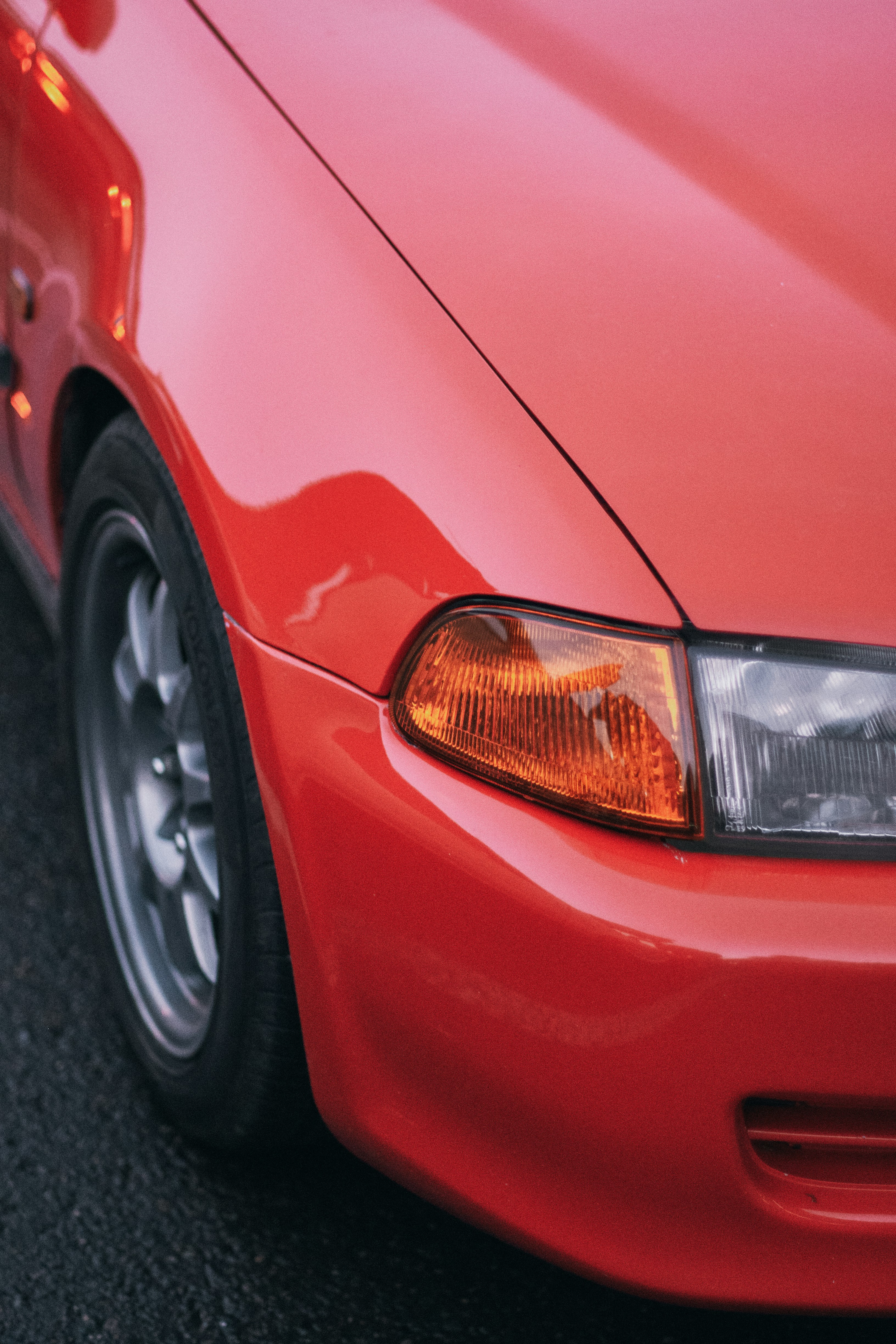 A close up of the front of a red car