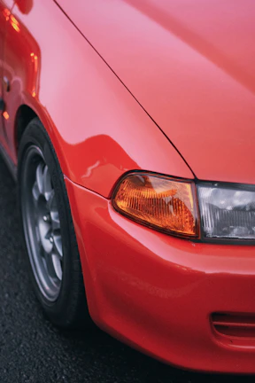 A close up of the front of a red car