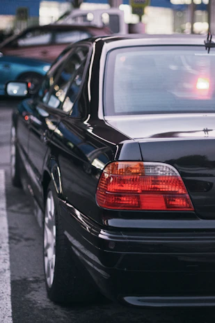 A black car parked on the side of the road