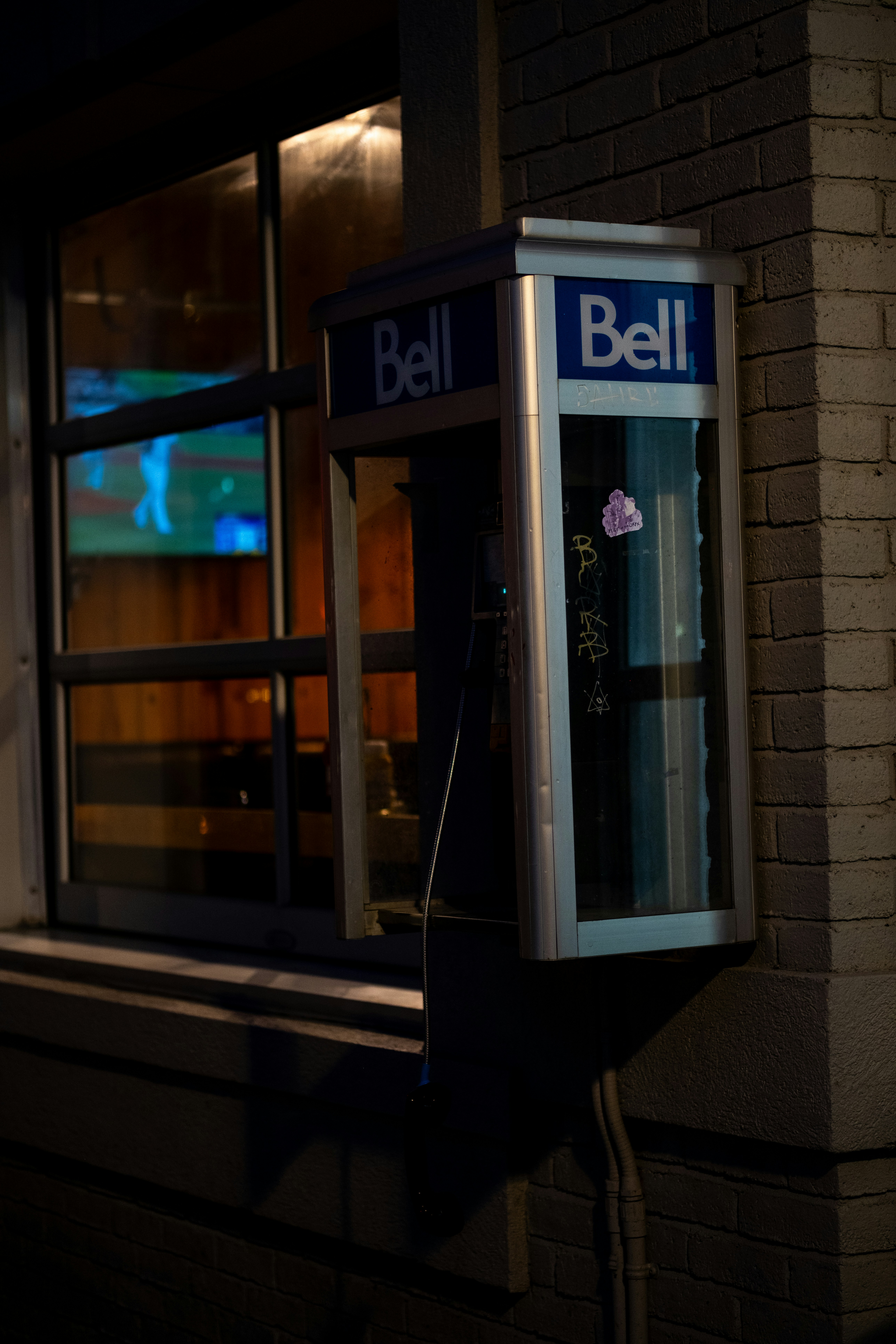 A phone booth on the side of a building