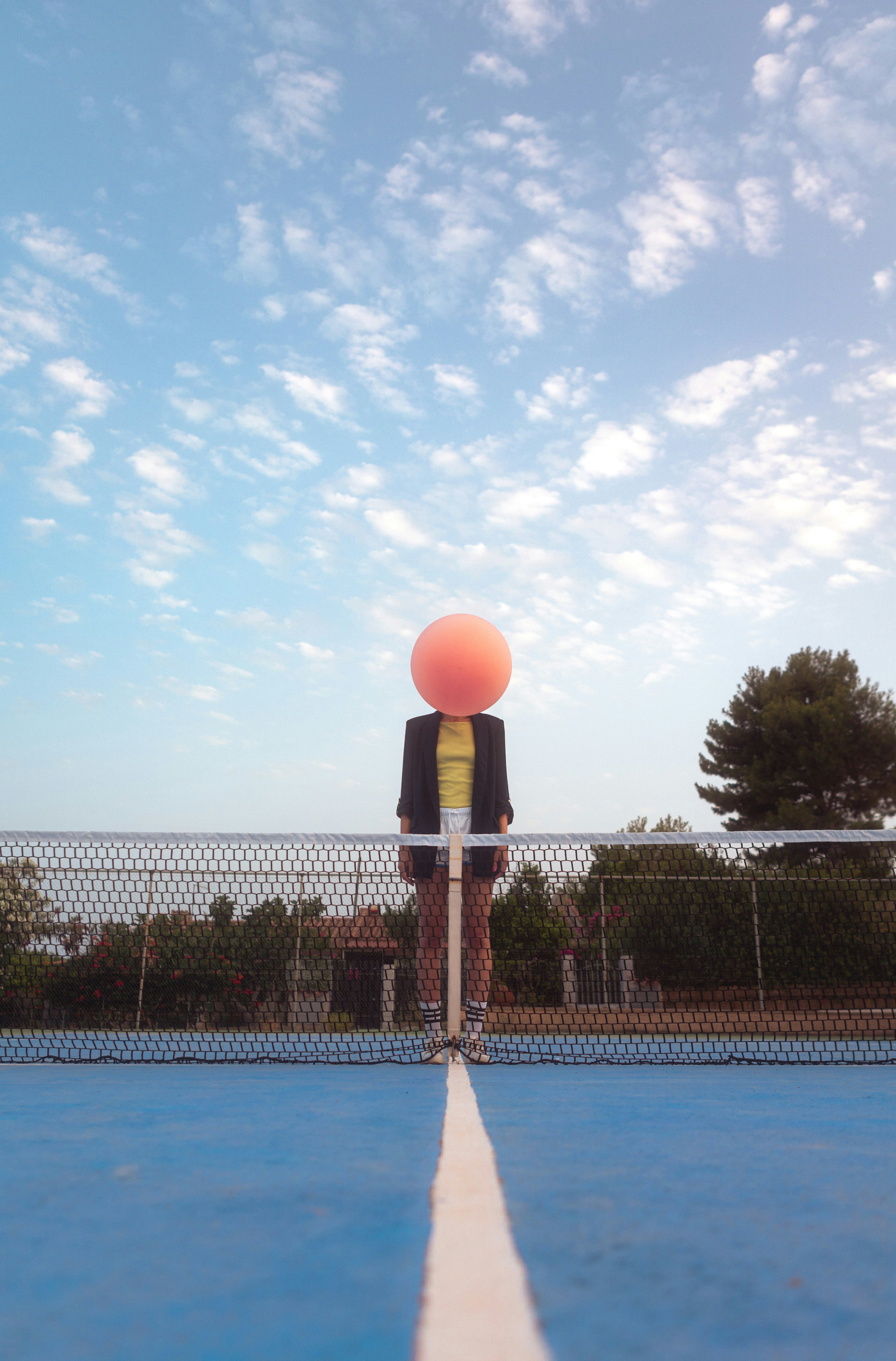 A person standing on a tennis court holding a racket