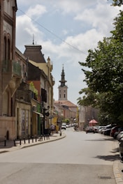 A city street with a clock tower in the background