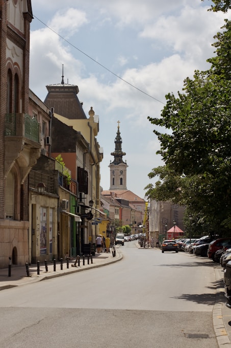 A city street with a clock tower in the background