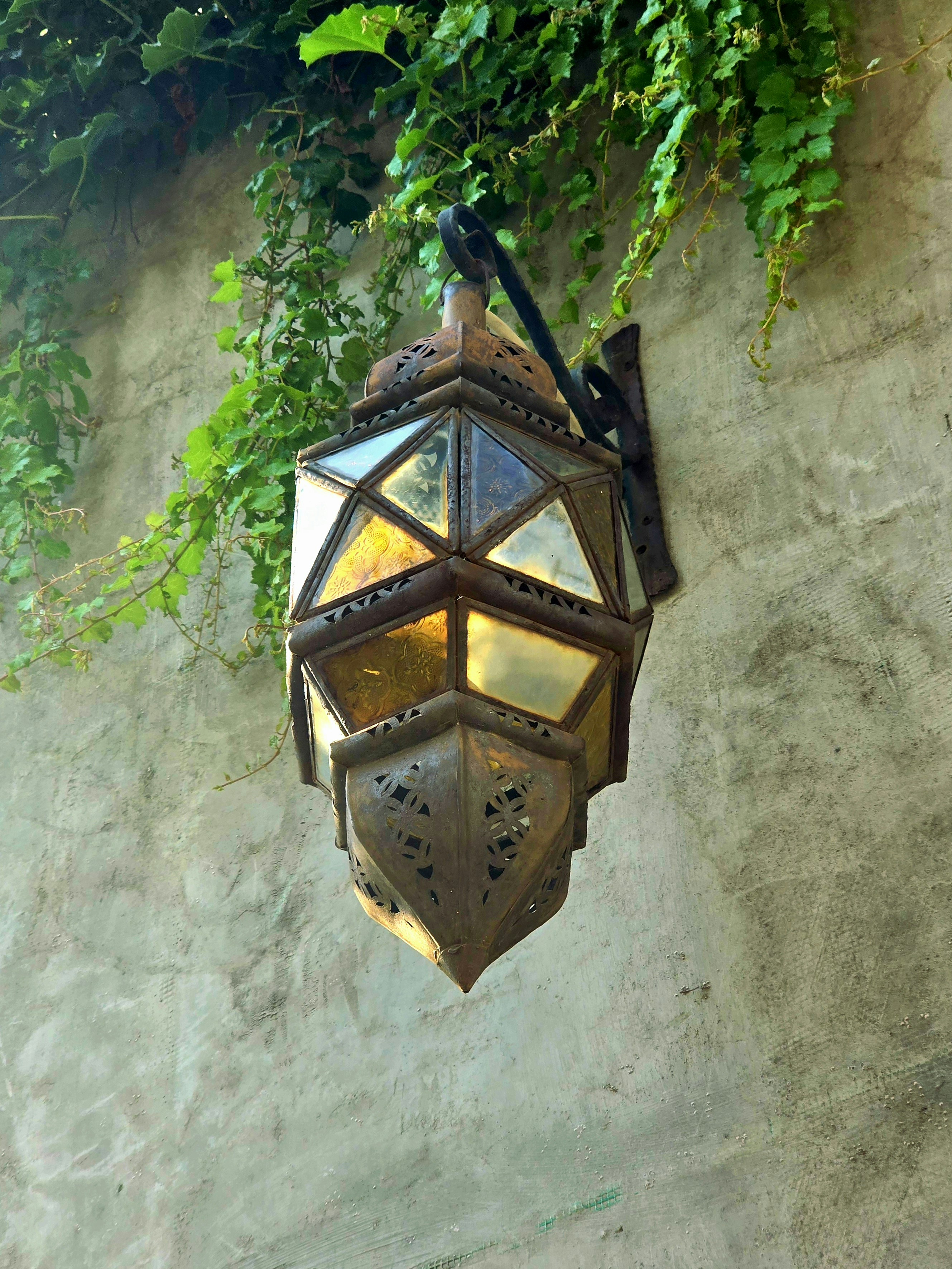 A lamp hanging from the side of a building