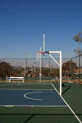A basketball court with a basketball hoop in the middle of it