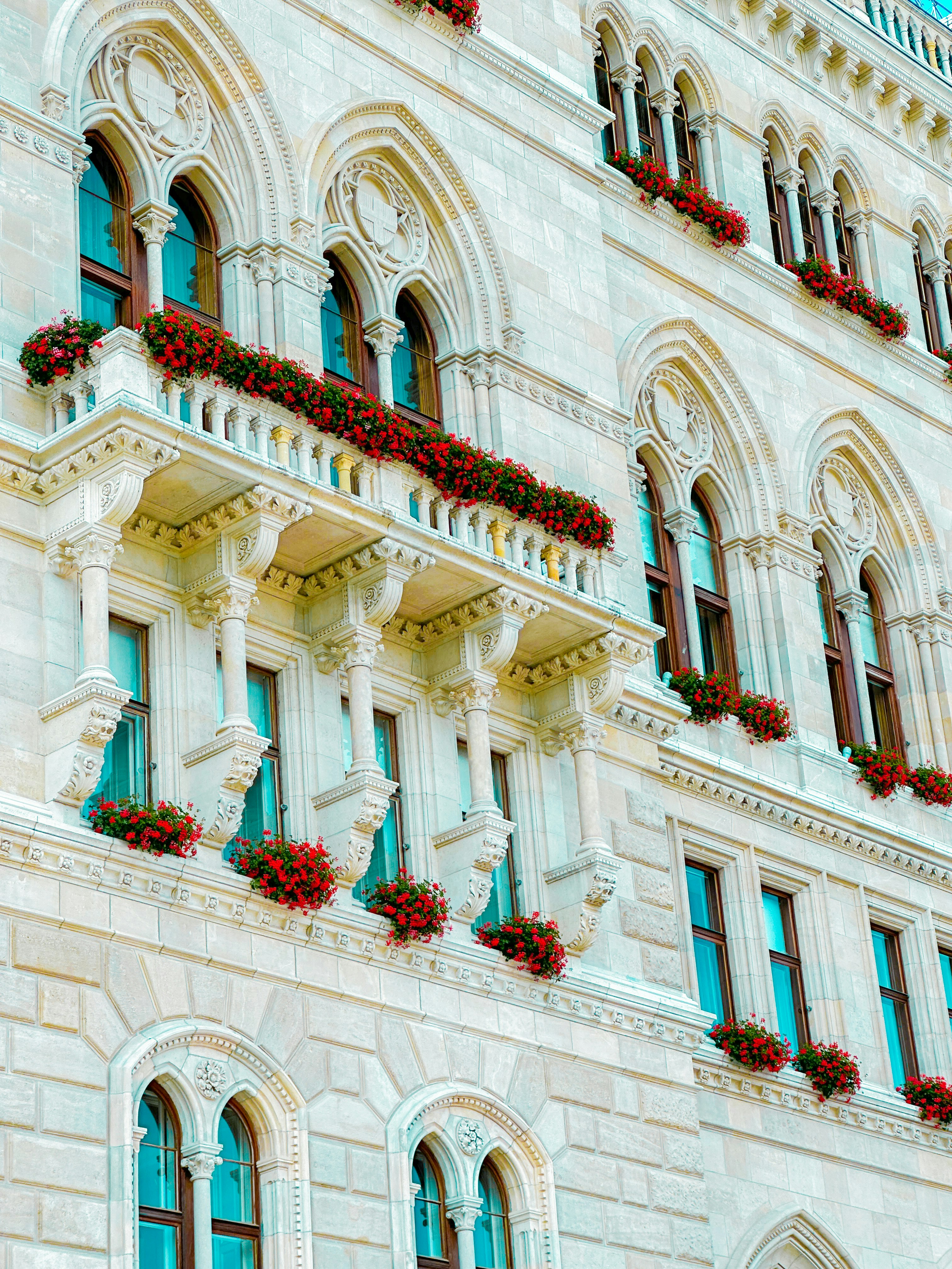 A large building with many windows and flowers on the balconies