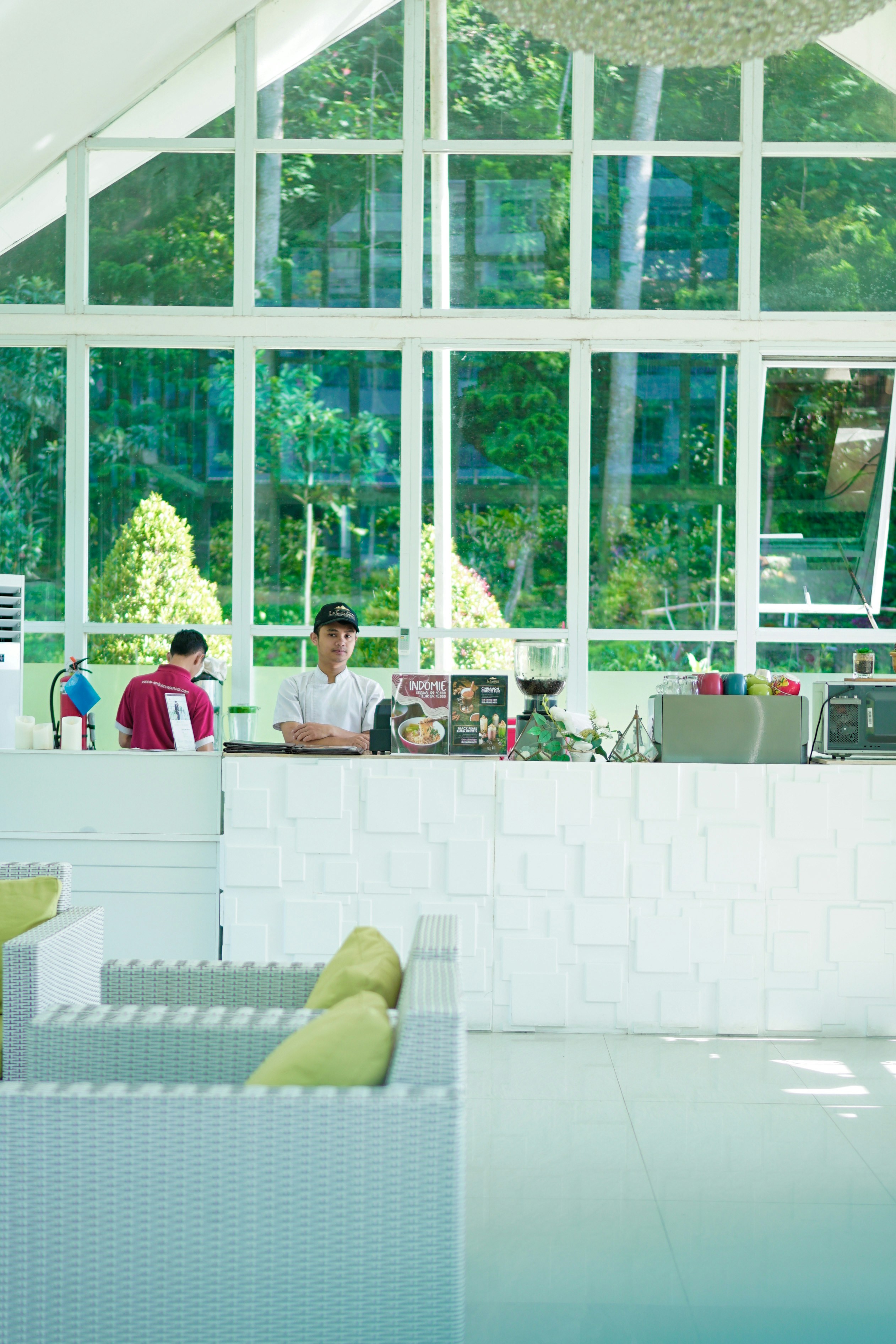 A restaurant with people sitting at the counter