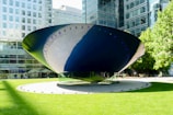 A large blue and white object sitting in the middle of a park