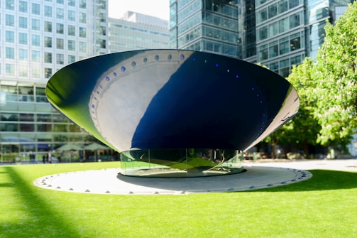 A large blue and white object sitting in the middle of a park