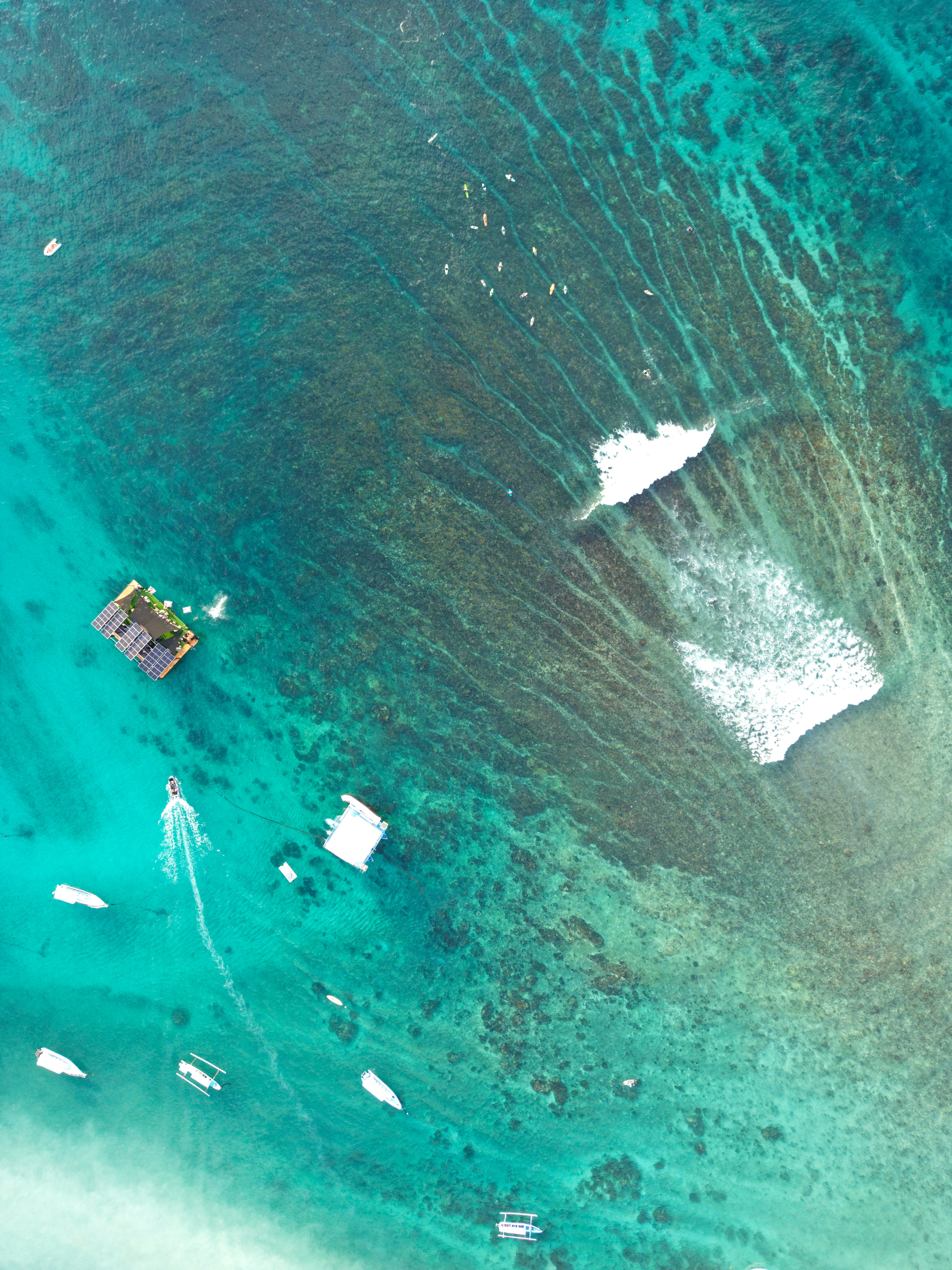 An aerial view of a boat in the ocean