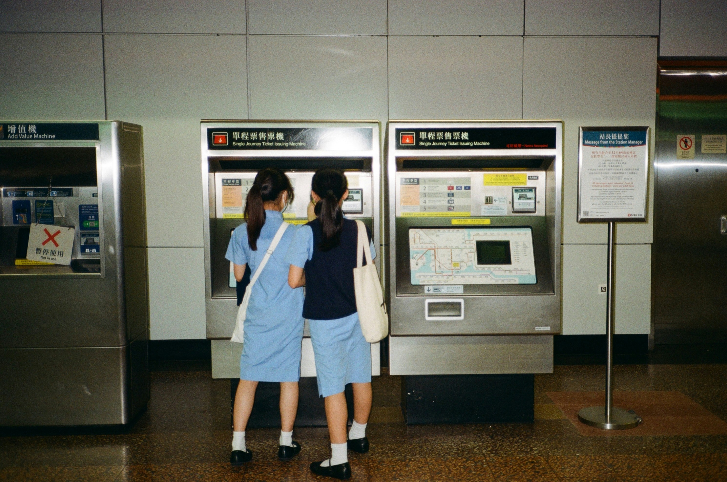 Two women standing in front of a machine