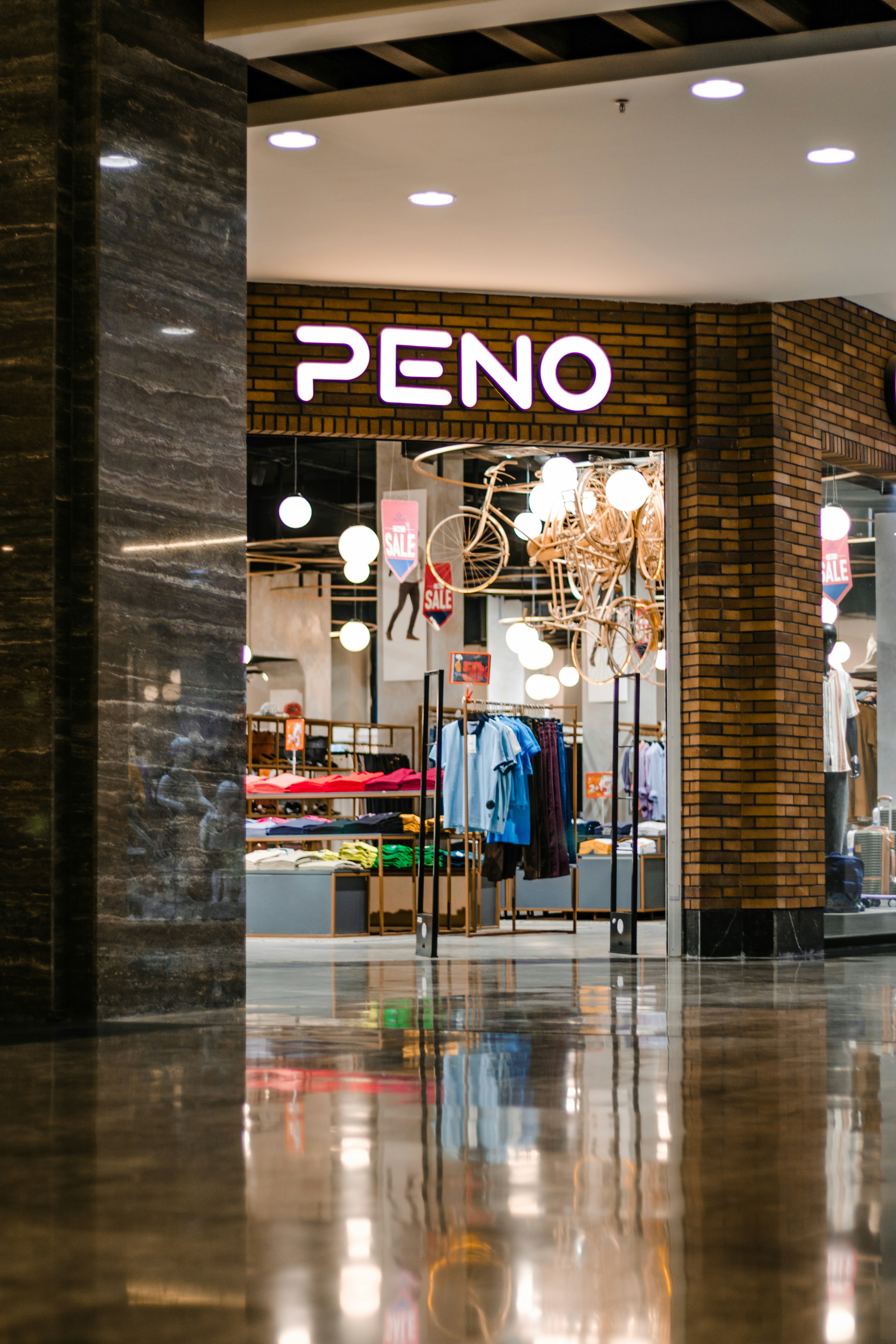 The entrance to a store with a chandelier hanging from the ceiling