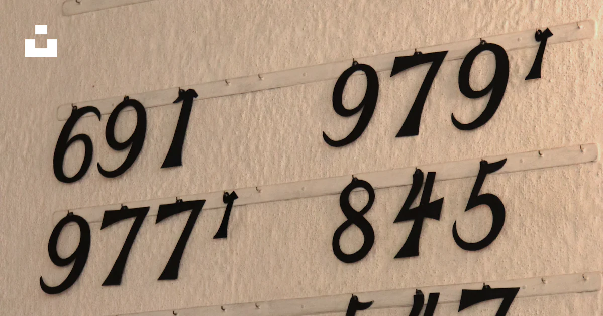 Wall With Numbers A white wall with numbers and numbers on it photo – Free Oslo Image on ...