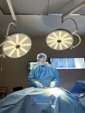 A surgeon is operating on a patient in the operating room