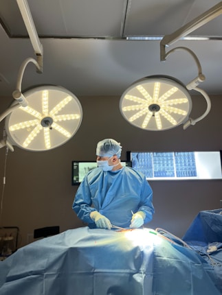 A surgeon is operating on a patient in the operating room