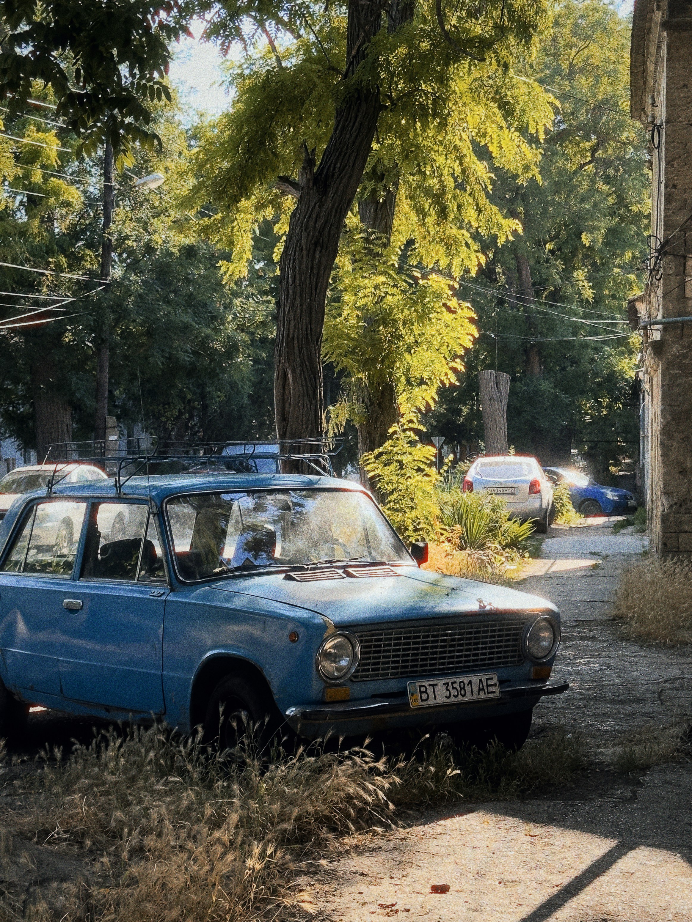 Un coche azul aparcado al costado de una carretera