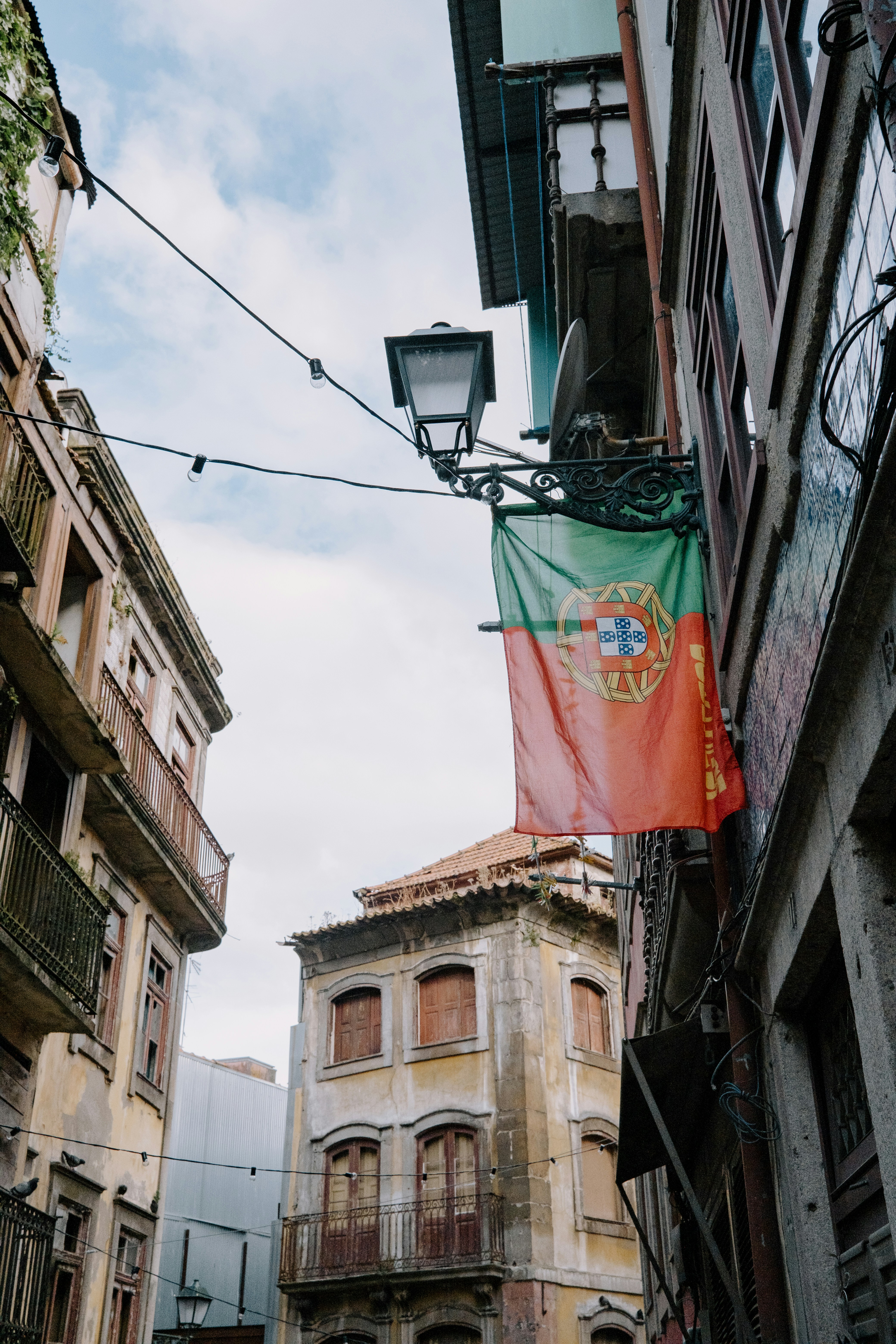 A street with a flag hanging from the side of buildings