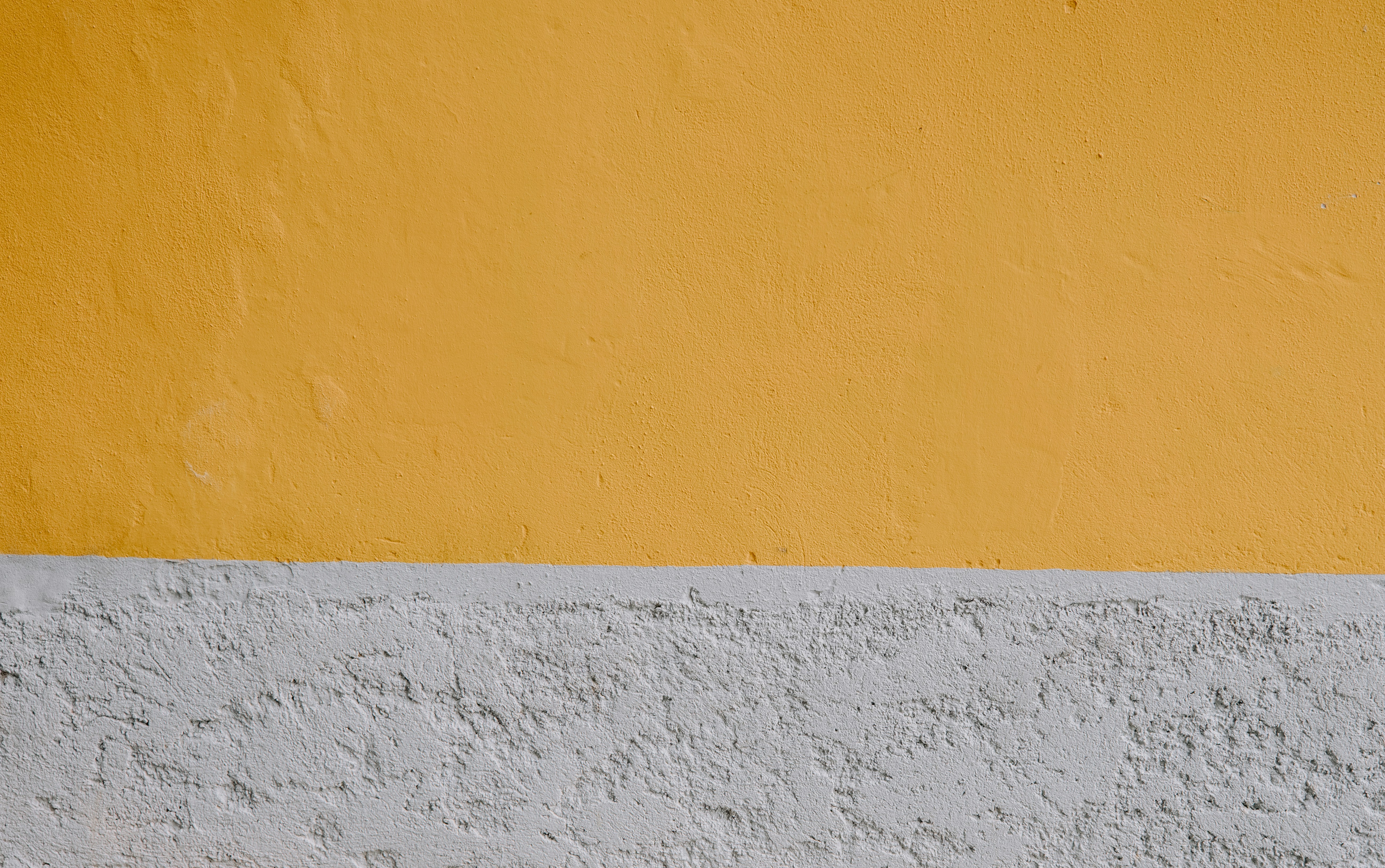 Yellow and white wall with clock