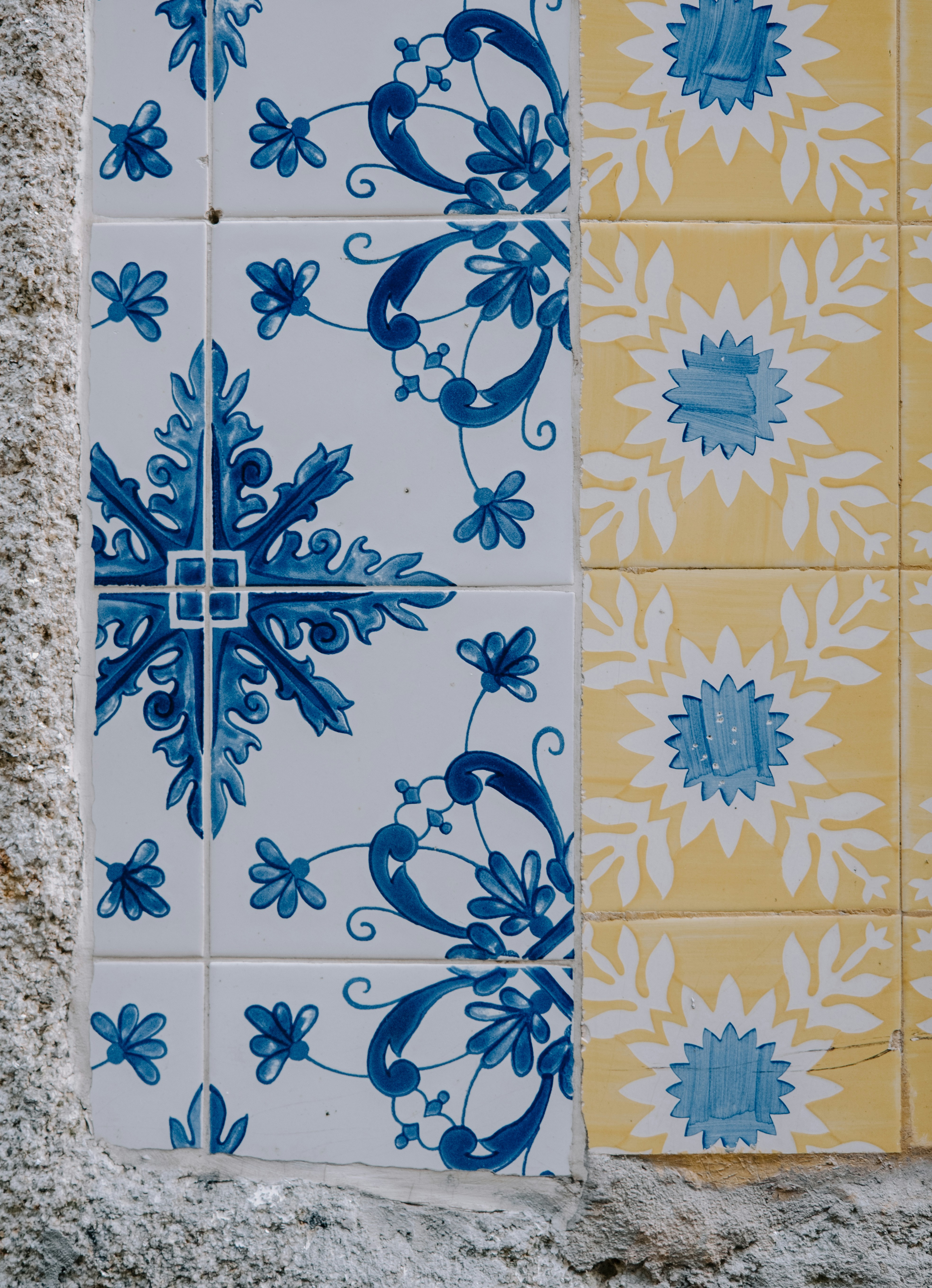 A blue and yellow tile with a cross on it