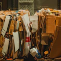 A pile of cardboard sitting on top of a wooden floor