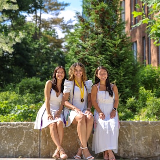 A group of young women sitting next to each other