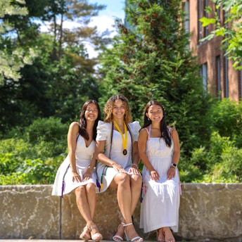 A group of young women sitting next to each other