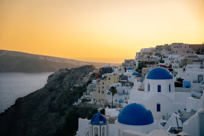 Blue-domed churches above the caldera on a Greek island.
