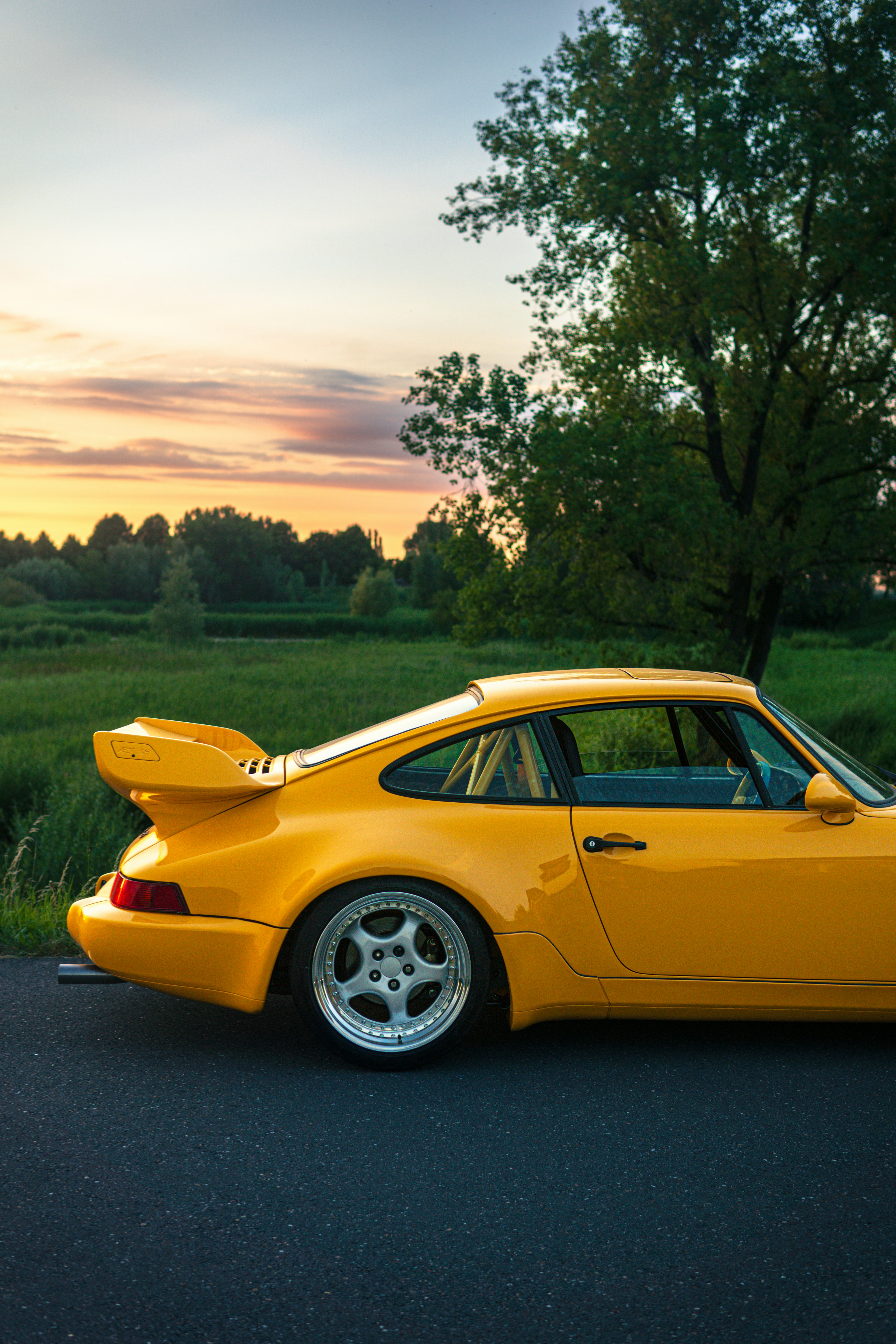 A yellow sports car parked on the side of the road