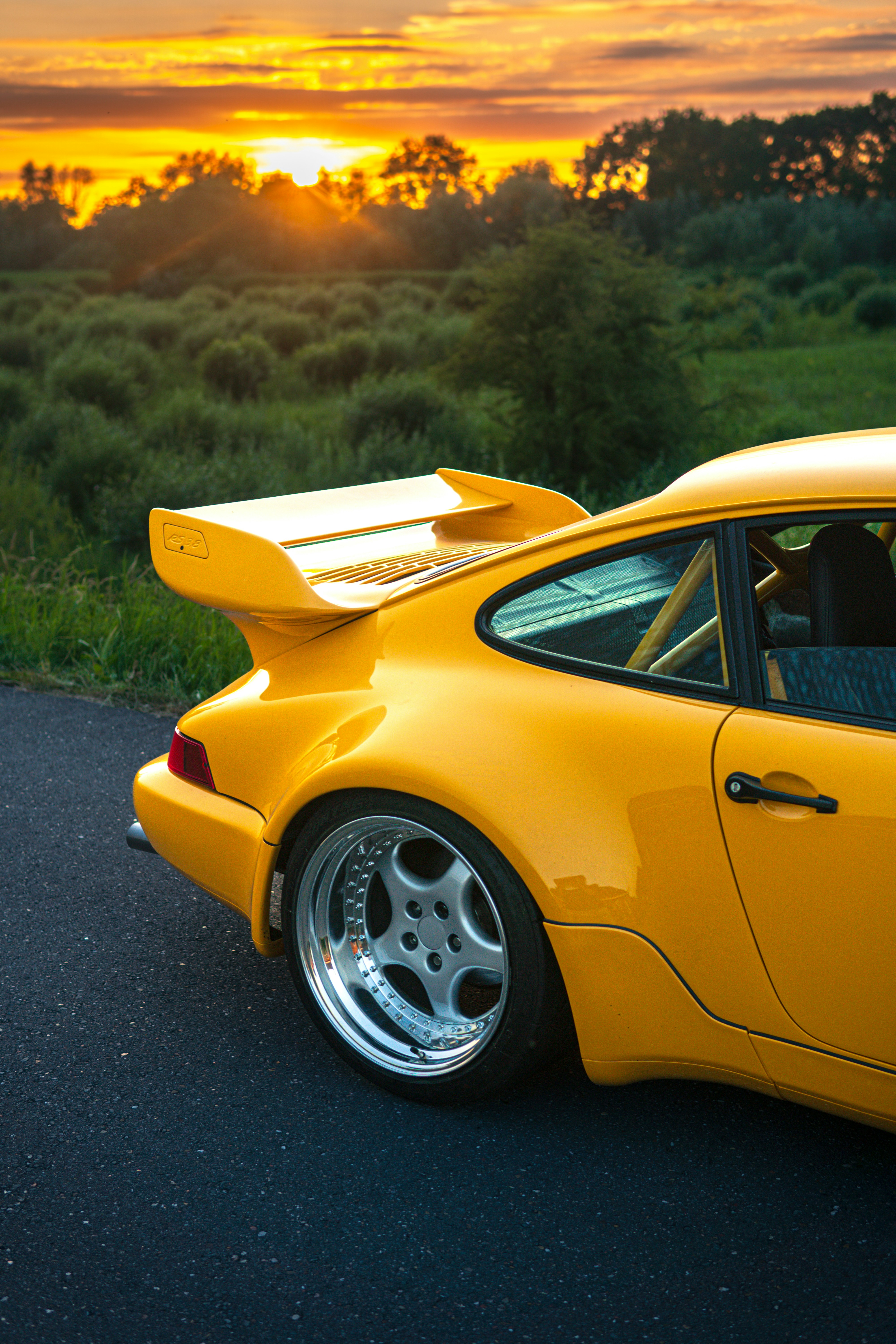 A yellow sports car parked on the side of the road