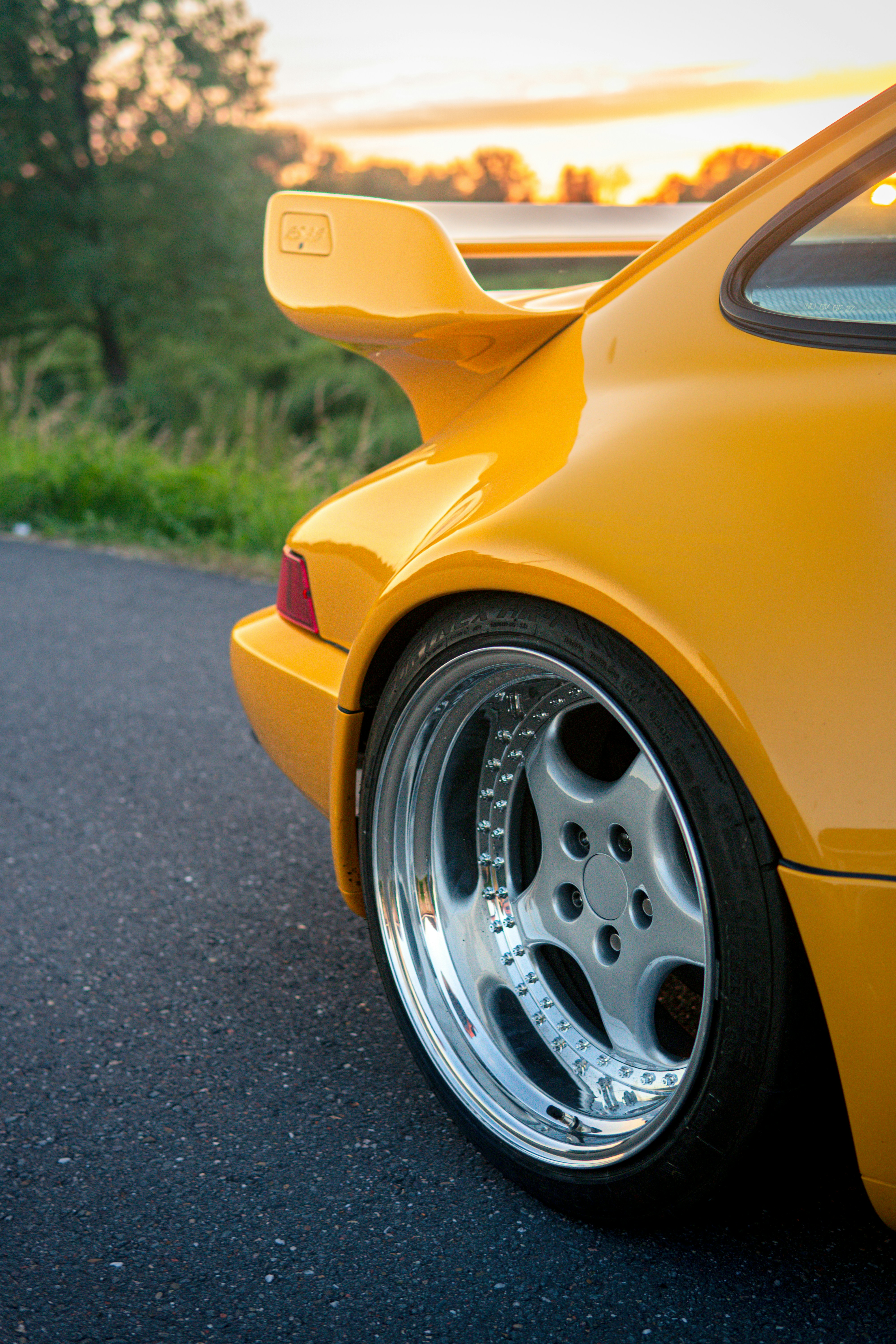 A yellow sports car parked on the side of the road