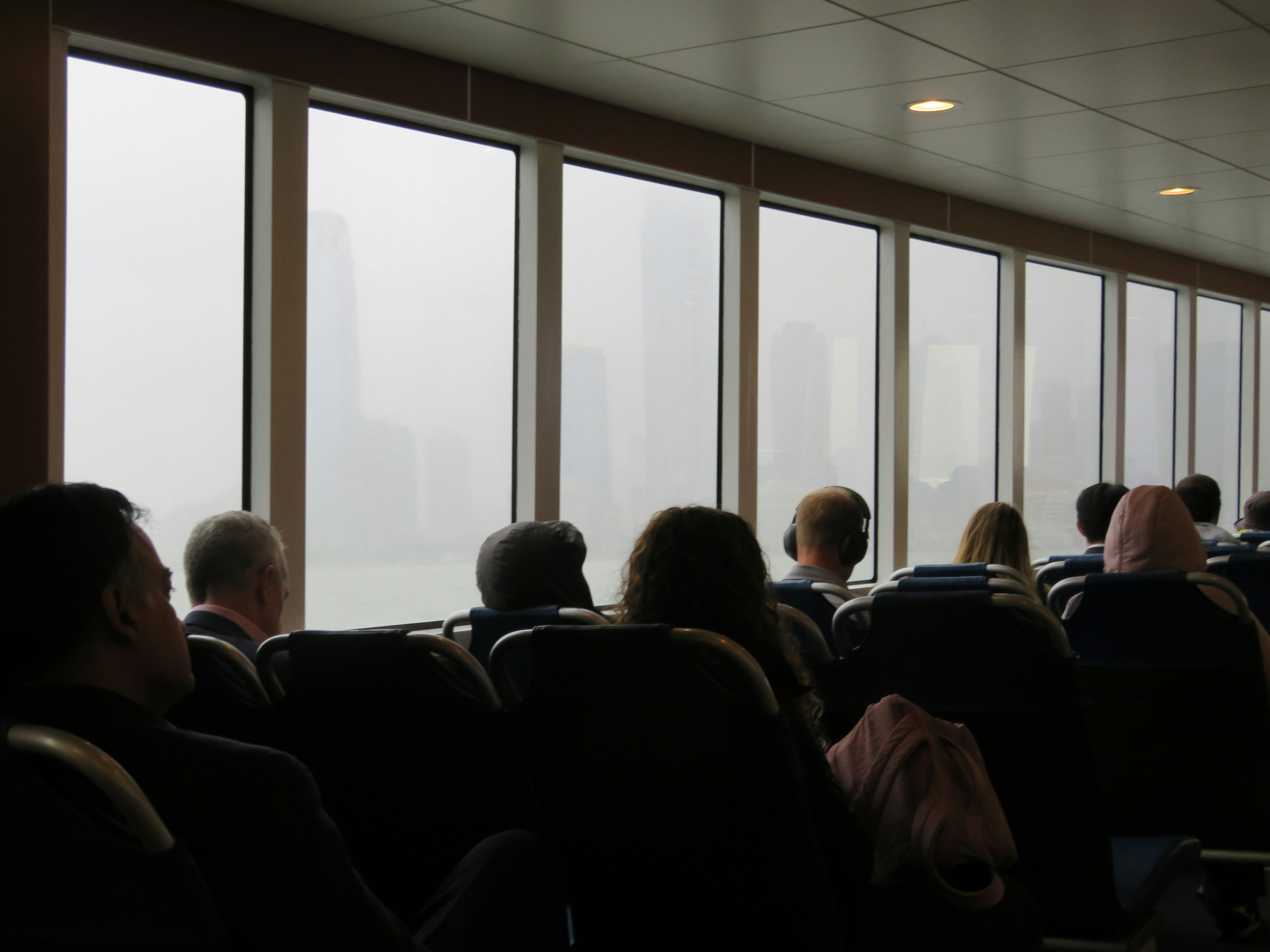 A group of people sitting in chairs in front of a window