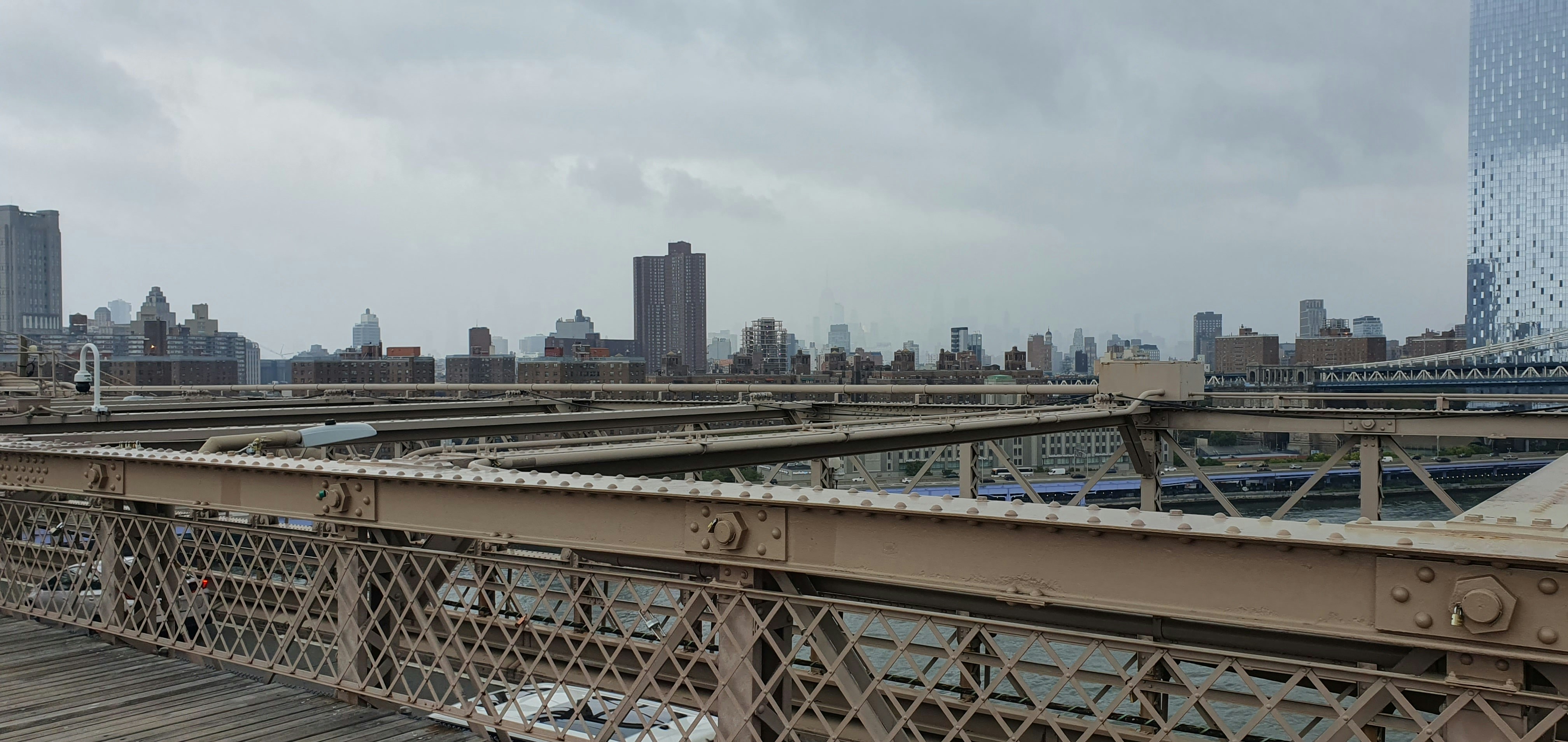 A view of a bridge with a city in the background