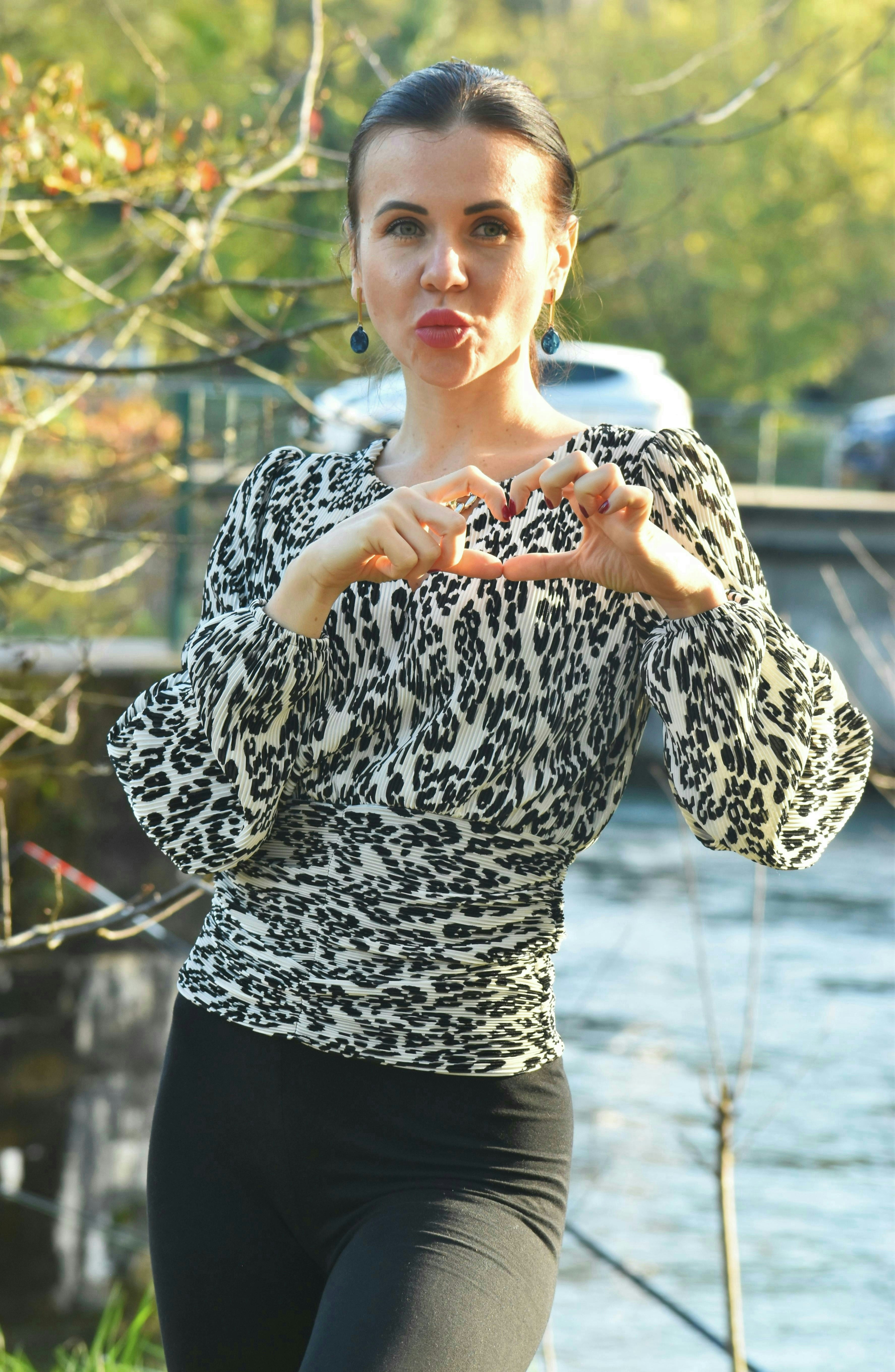 A woman standing in front of a body of water