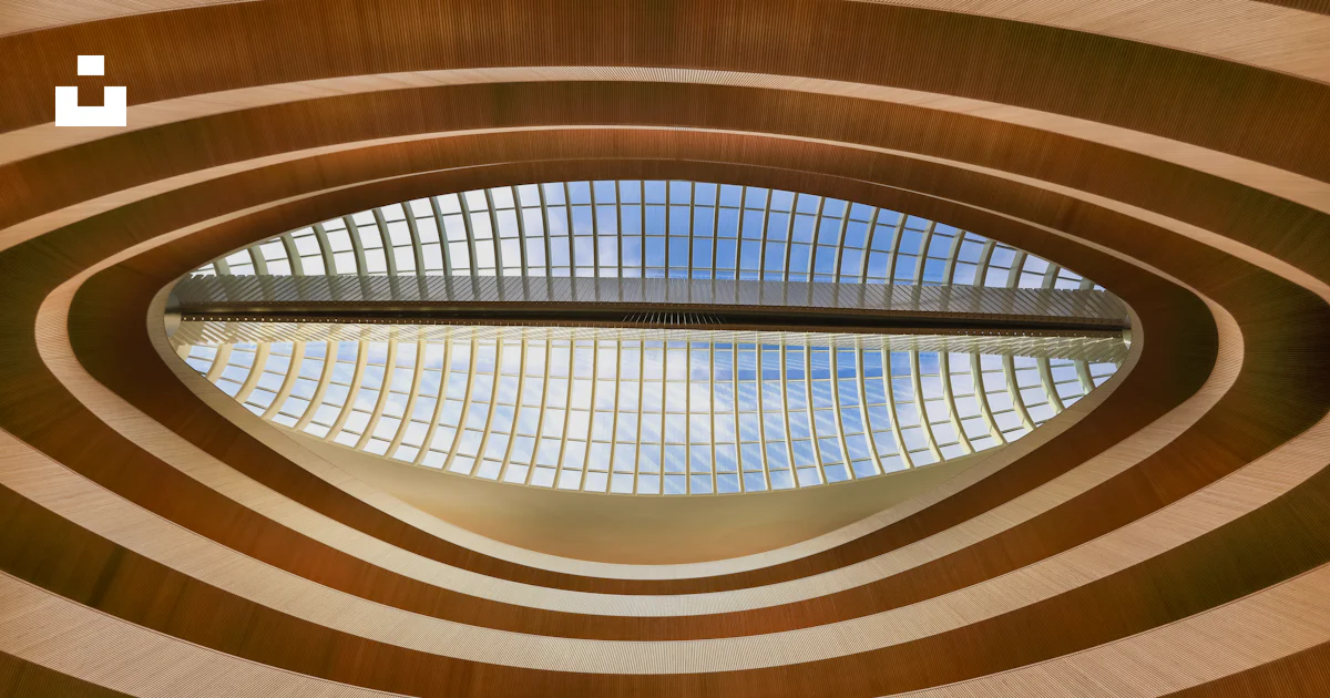 Circular Window Pattern A building that has a circular window in it photo – Free Brown Image on ...