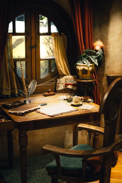 A desk with a chair and a lamp on it for writing about walking with Jesus.