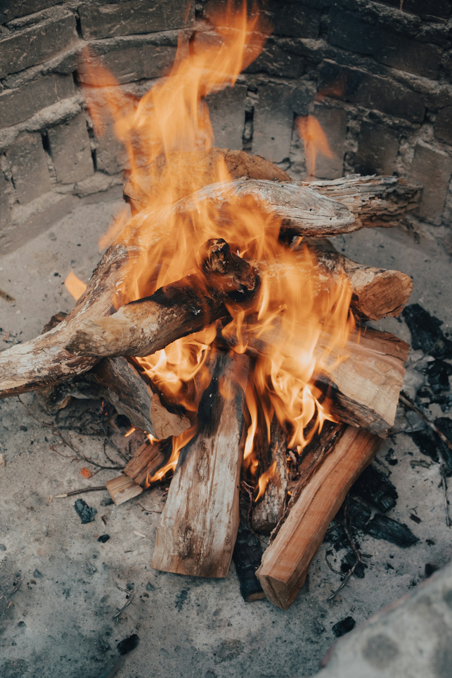 A fire is burning in a stone fire pit