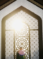 A person standing in front of a window