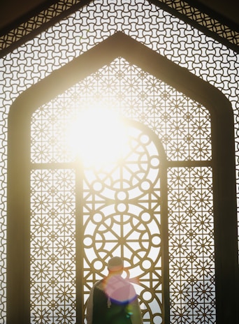 A person standing in front of a window