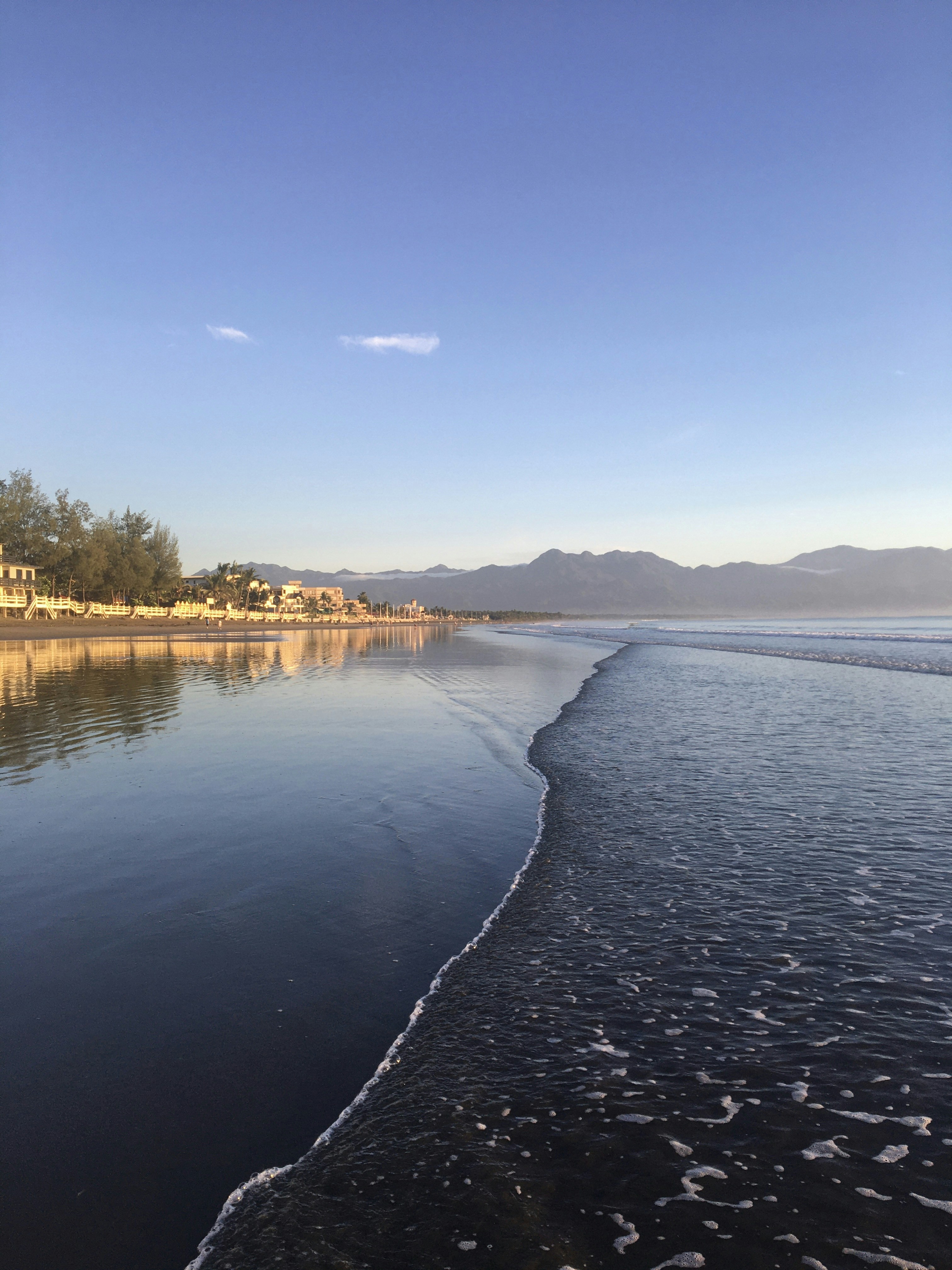 A body of water sitting next to a beach