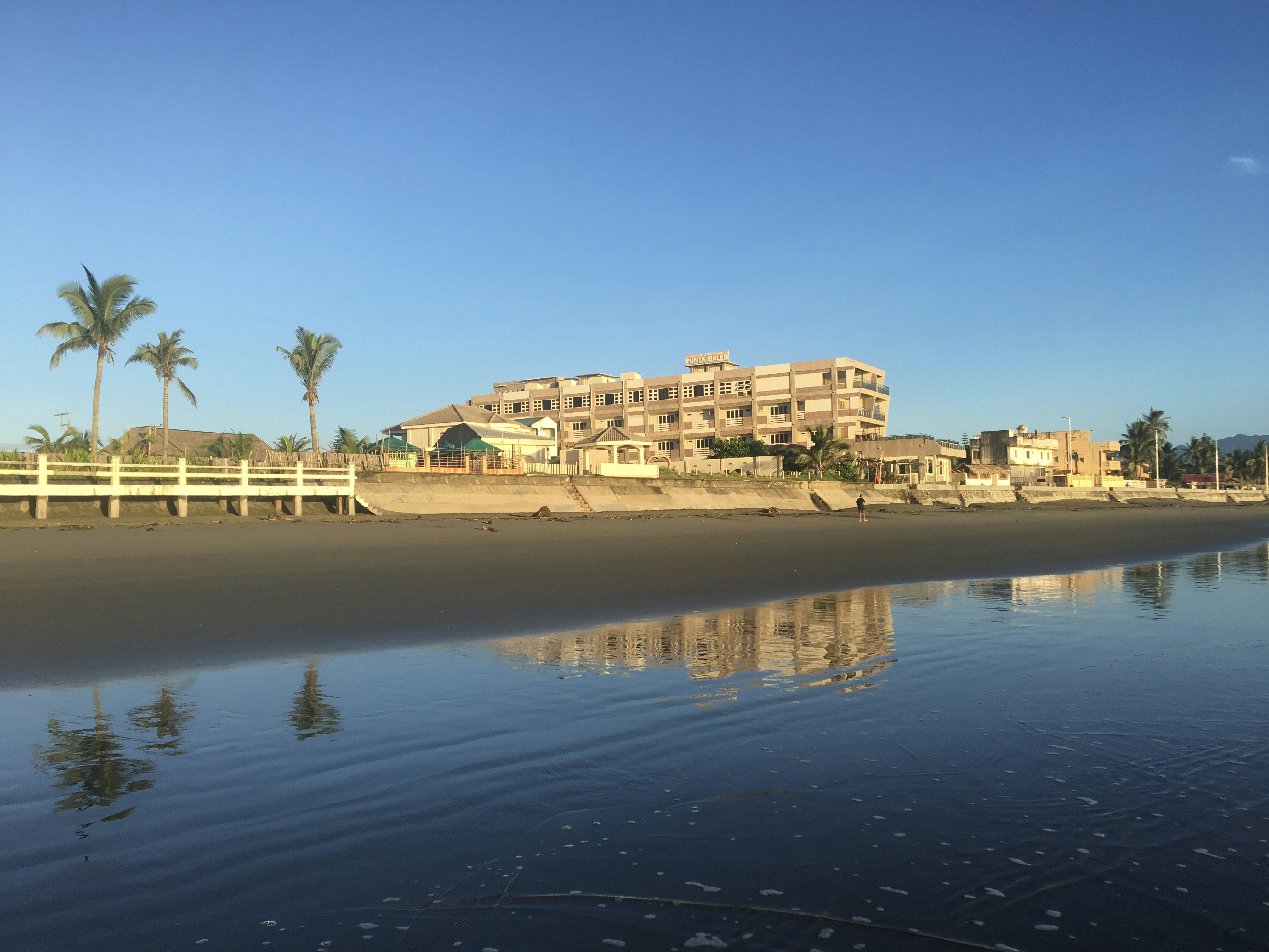 A view of a beach with a building in the background