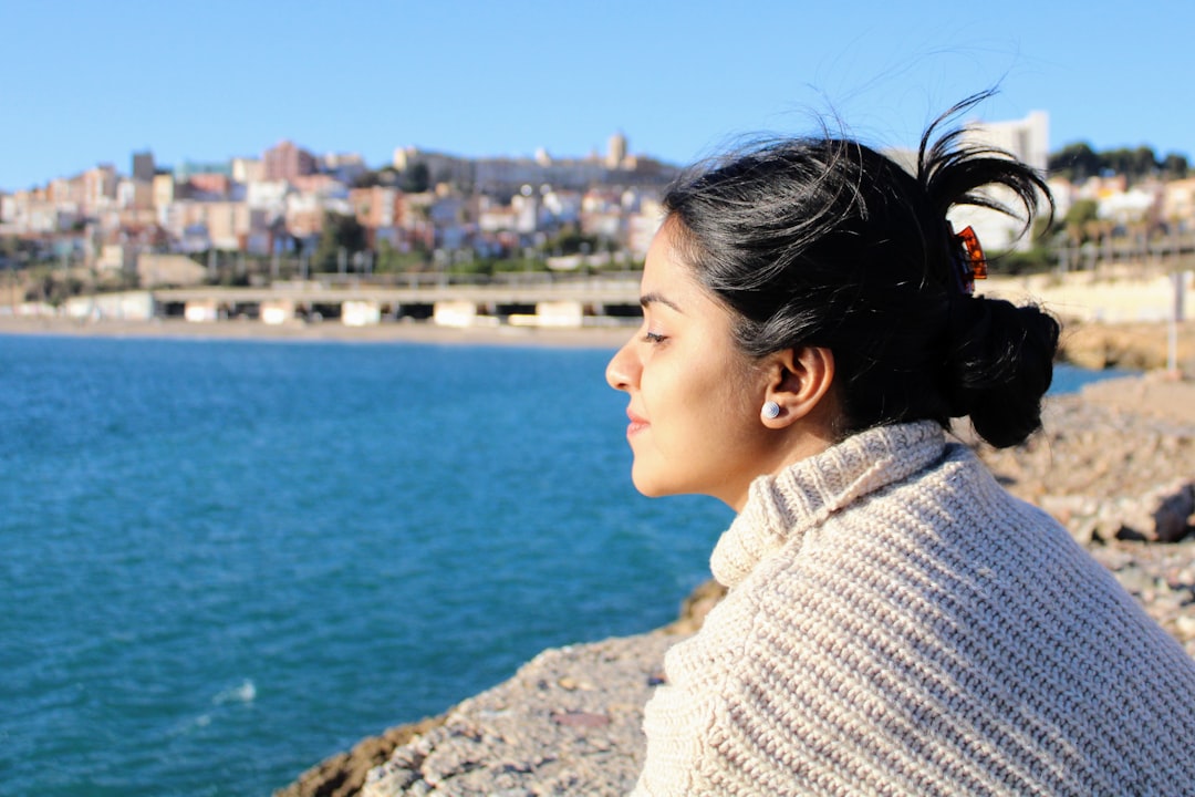 A woman looking out over a body of water,
