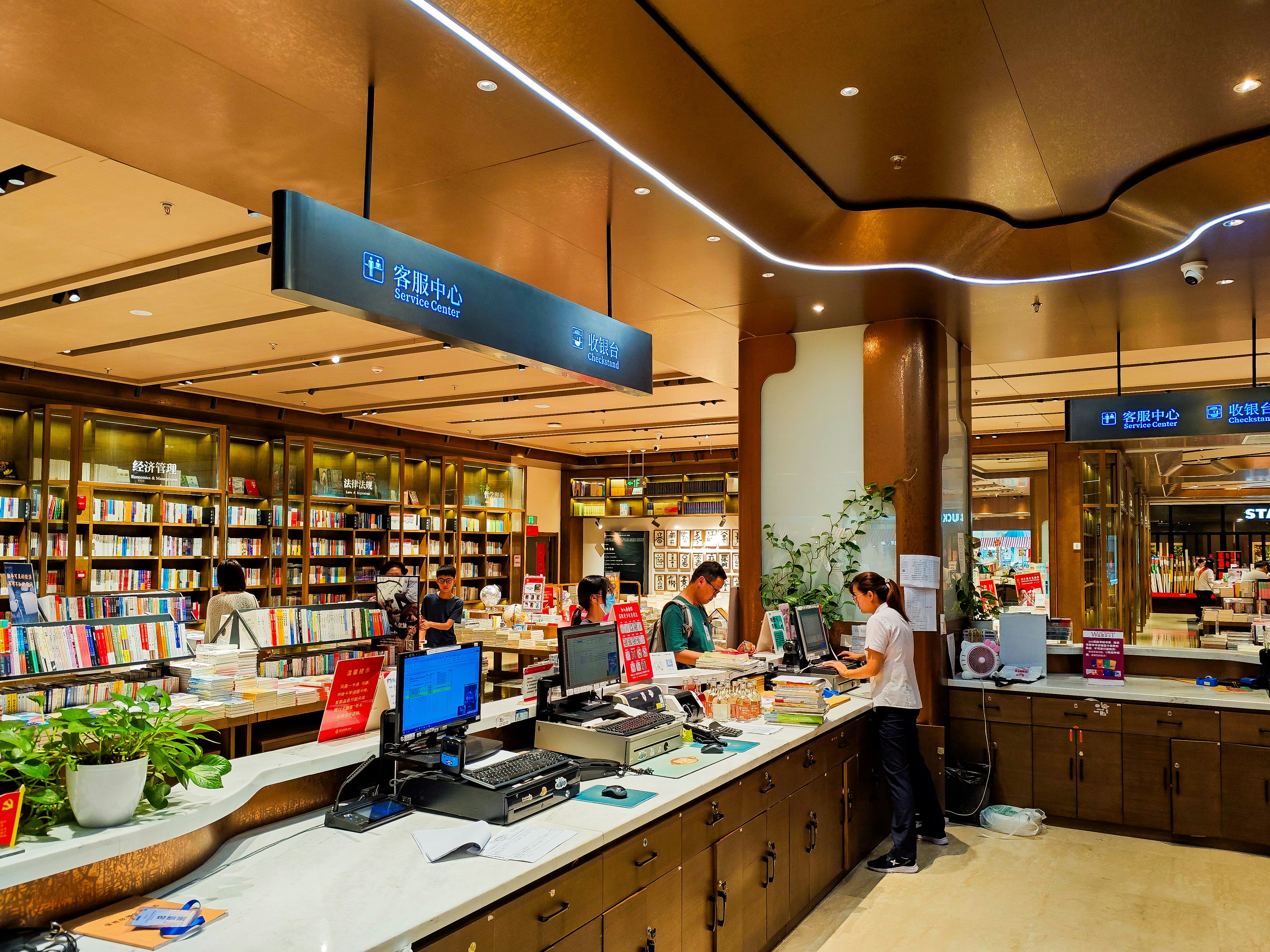 A library filled with lots of books and people