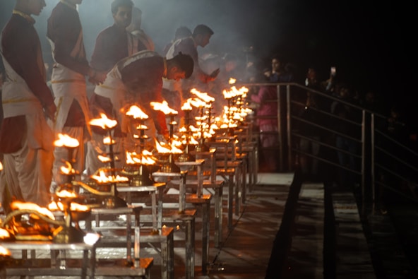 A group of people standing around a table covered in fire