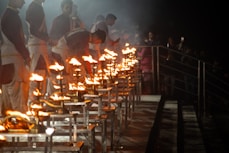 A group of people standing around a table covered in fire