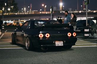 A black car parked on the side of the road
